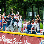 A large crowd of spectators cheering.